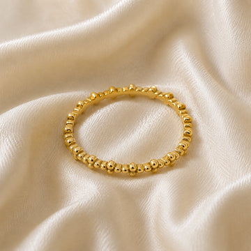Minimal_ring_in_gold_plated_silver_at_front_angle_on_soft_fabric_background