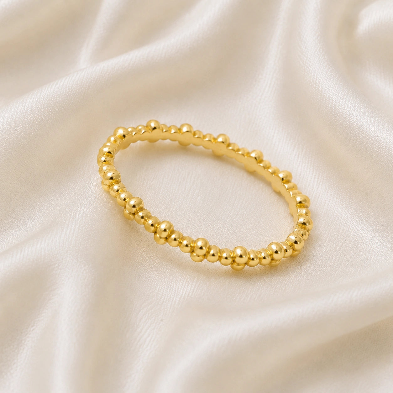 Minimal_ring_in_gold_plated_silver_at_slightly_angled_on_soft_fabric_background