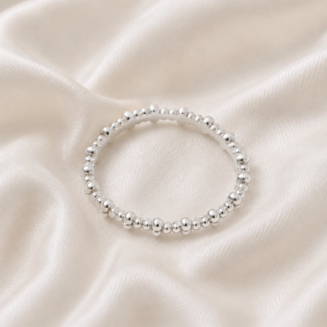 Minimal_ring_in_gold_plated_silver_at_front_angle_on_soft_fabric_background