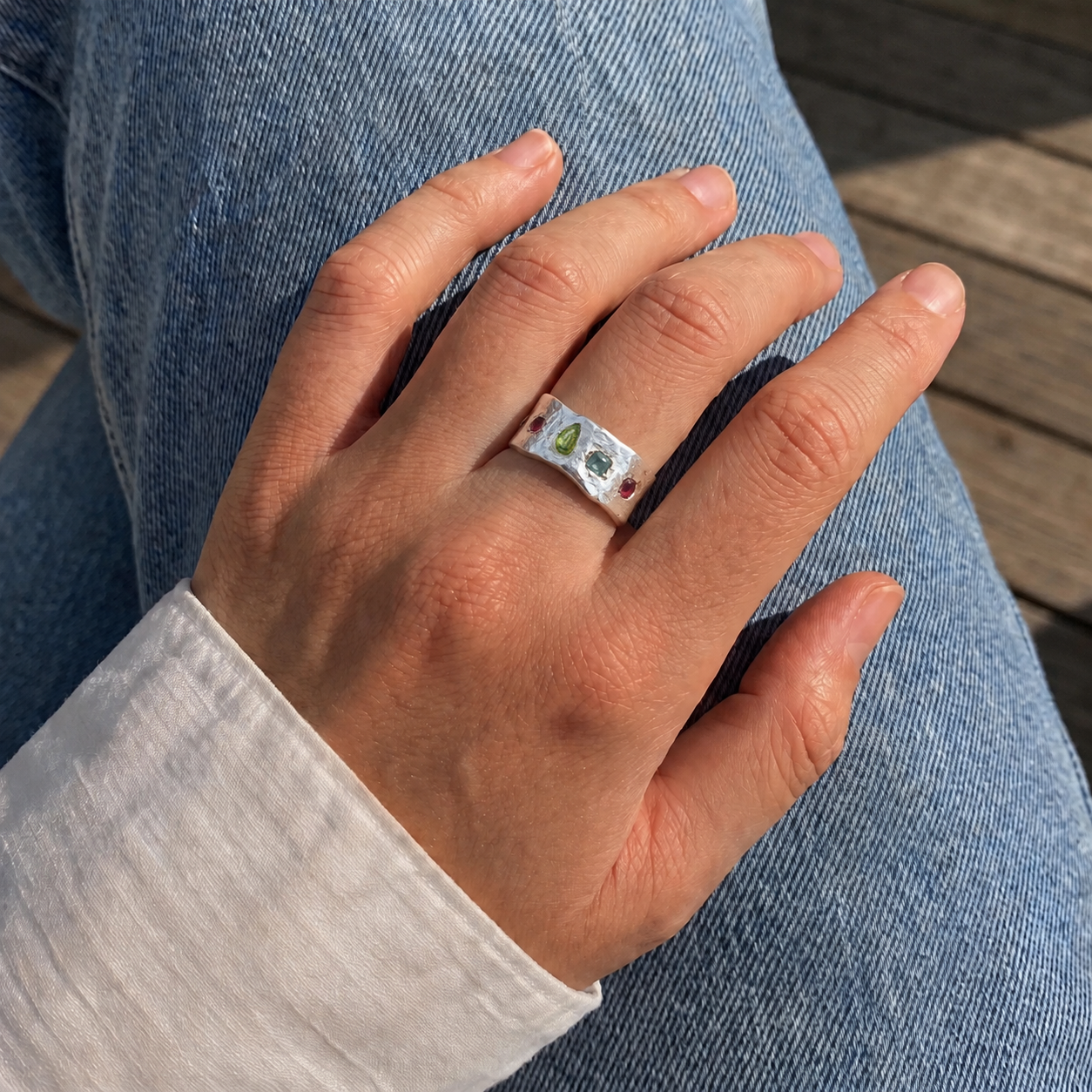 Chunky_ring_in_sterling_silver_with_pink_tourmaline_peridot_and_blue_topaz_stones_worn_by_a_model