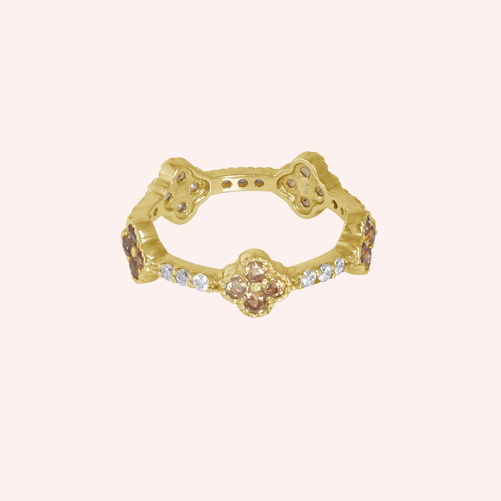Citrine_ring_gold_plated_silver_floral_band_with_citrine_and_white_topaz_in_front_angle_view_on_solid_pink_background