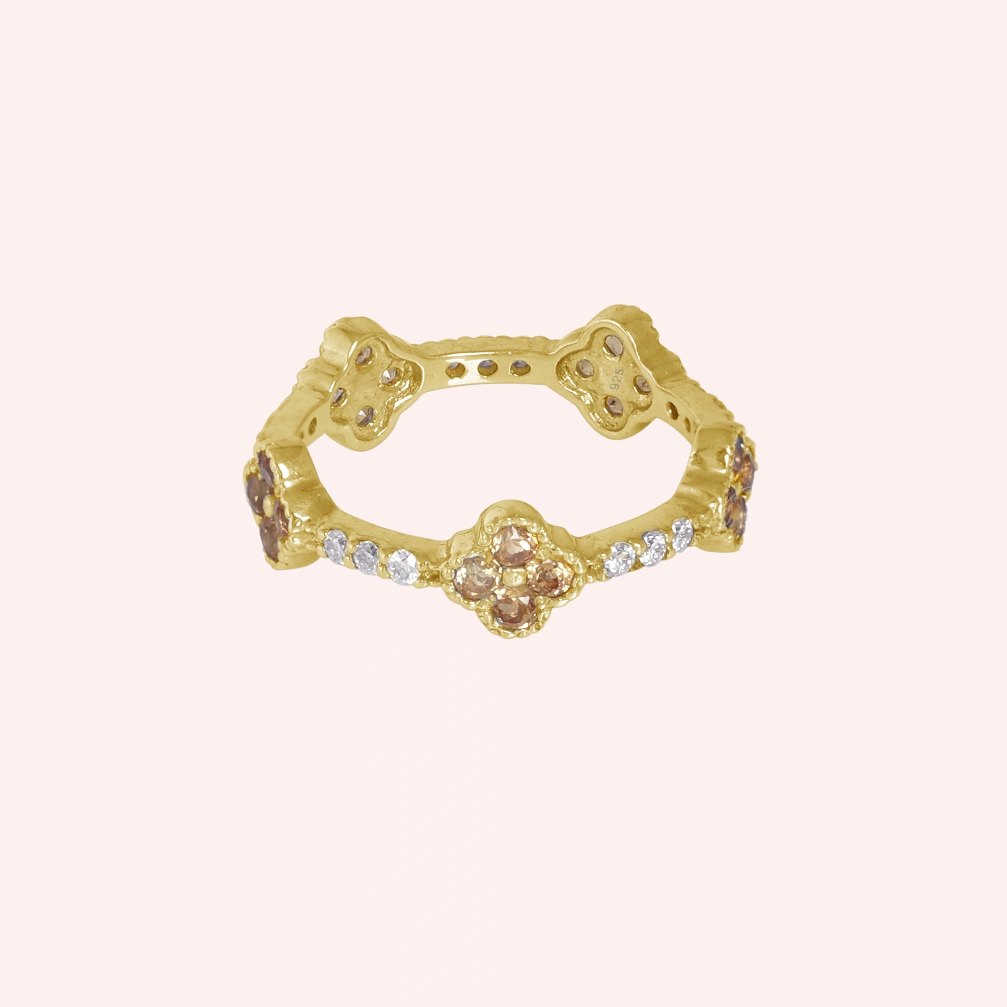 Citrine_ring_gold_plated_silver_floral_band_with_citrine_and_white_topaz_in_front_angle_view_on_solid_pink_background