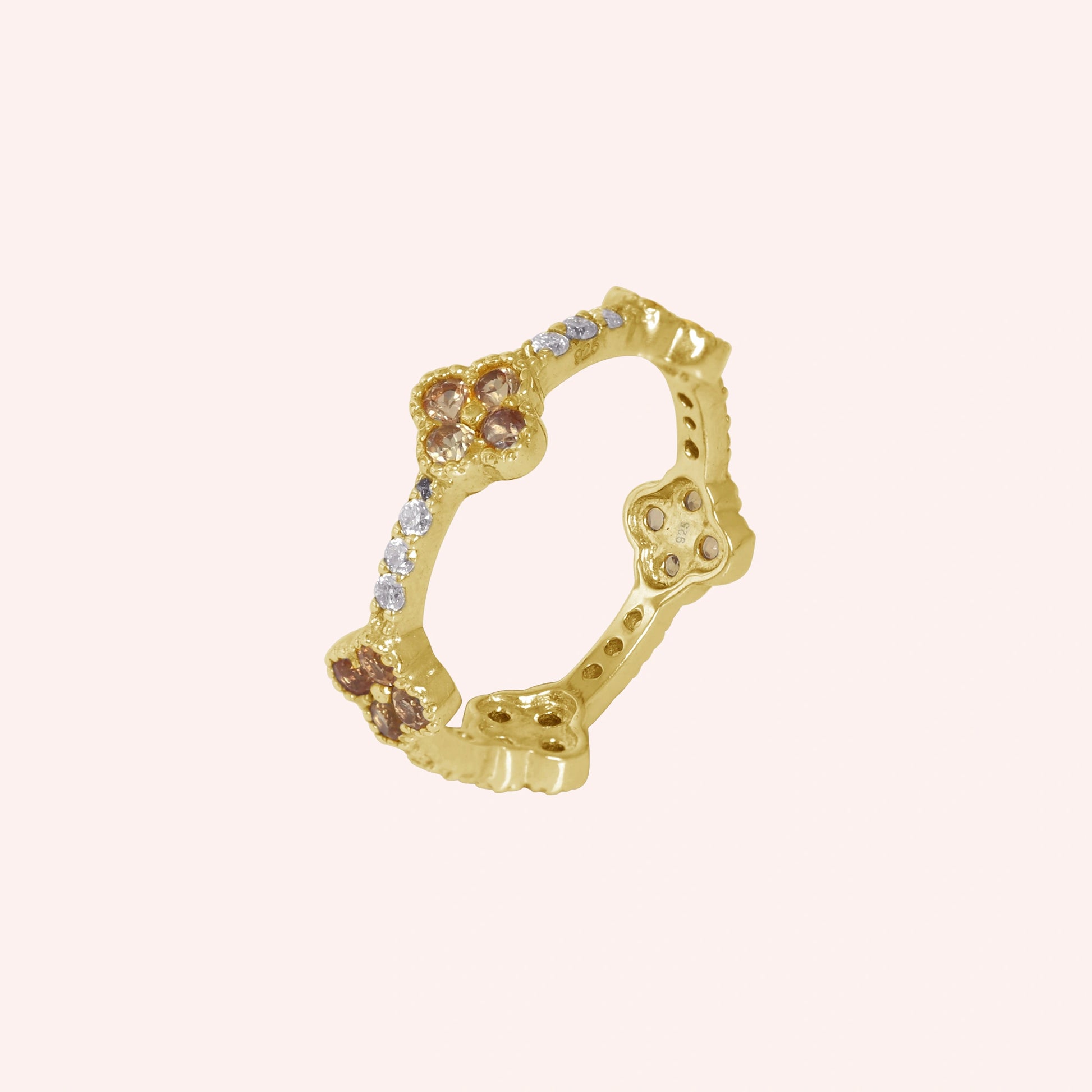 Citrine_ring_gold_plated_silver_floral_band_with_citrine_and_white_topaz_in_slightly_tilted_on_solid_pink_background