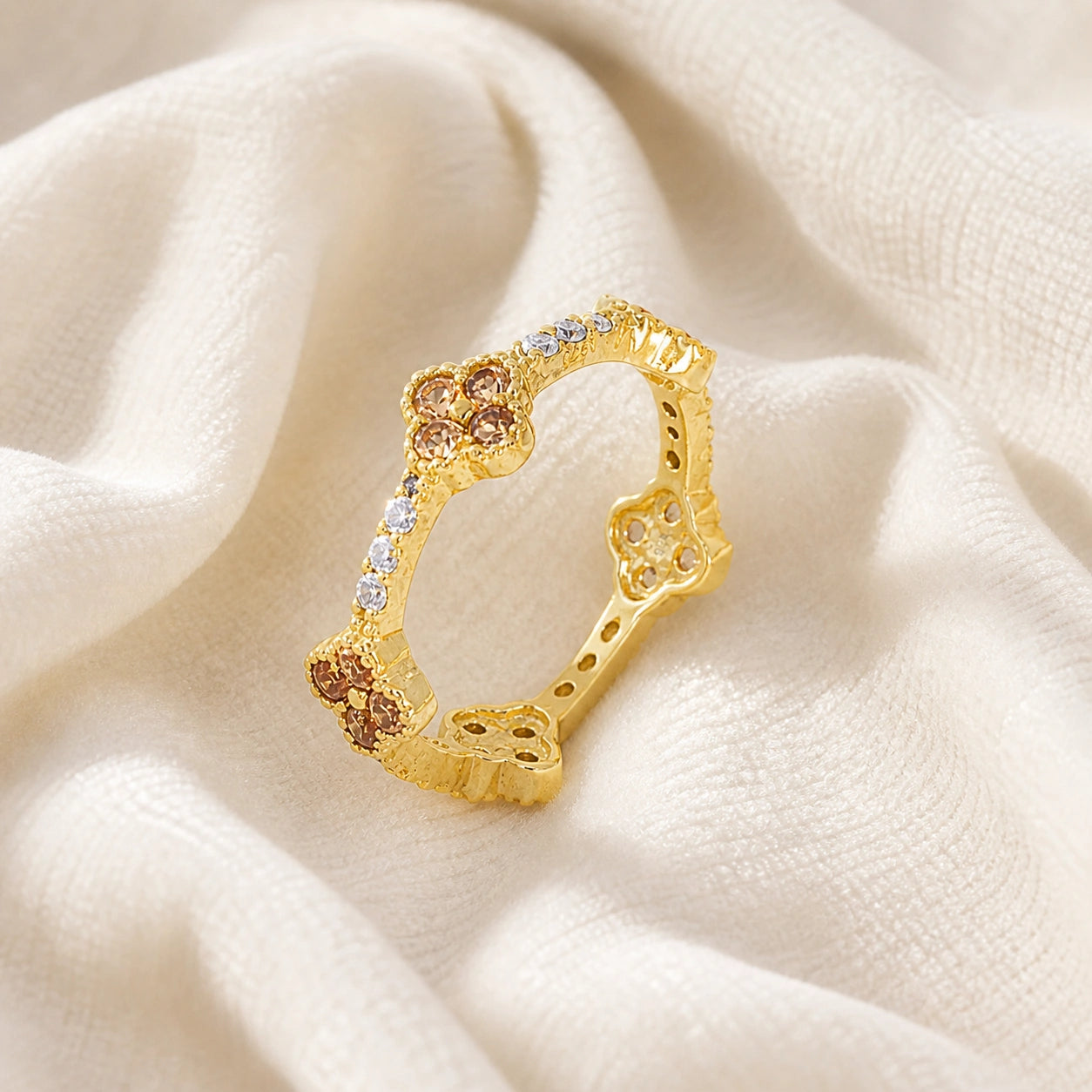 Citrine_ring_gold_plated_silver_floral_band_with_citrine_and_white_topaz_in_slightly_tilted_on_soft_fabric_background