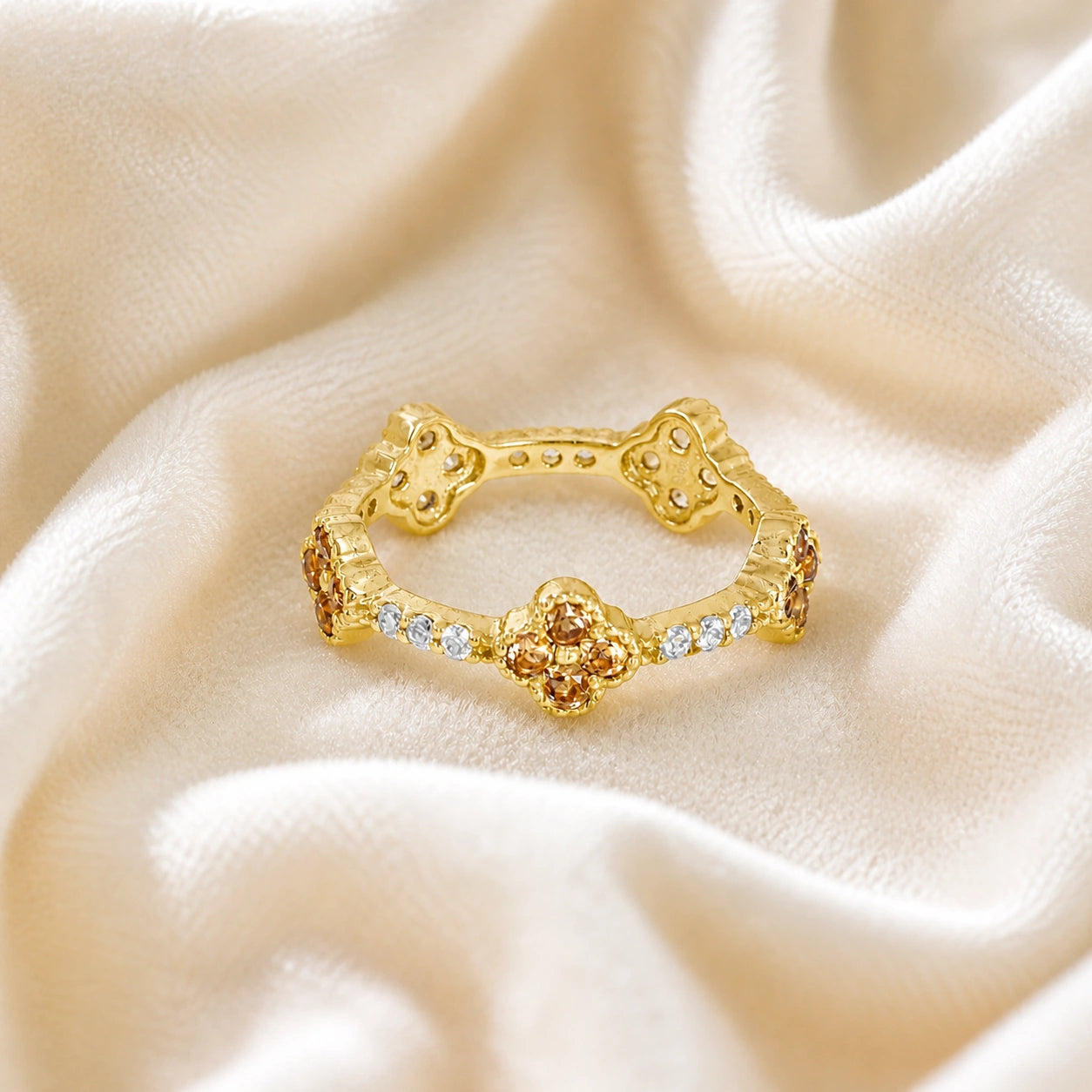 Citrine_ring_gold_plated_silver_floral_band_with_citrine_and_white_topaz_in_front_angle_view_on_soft_fabric_background