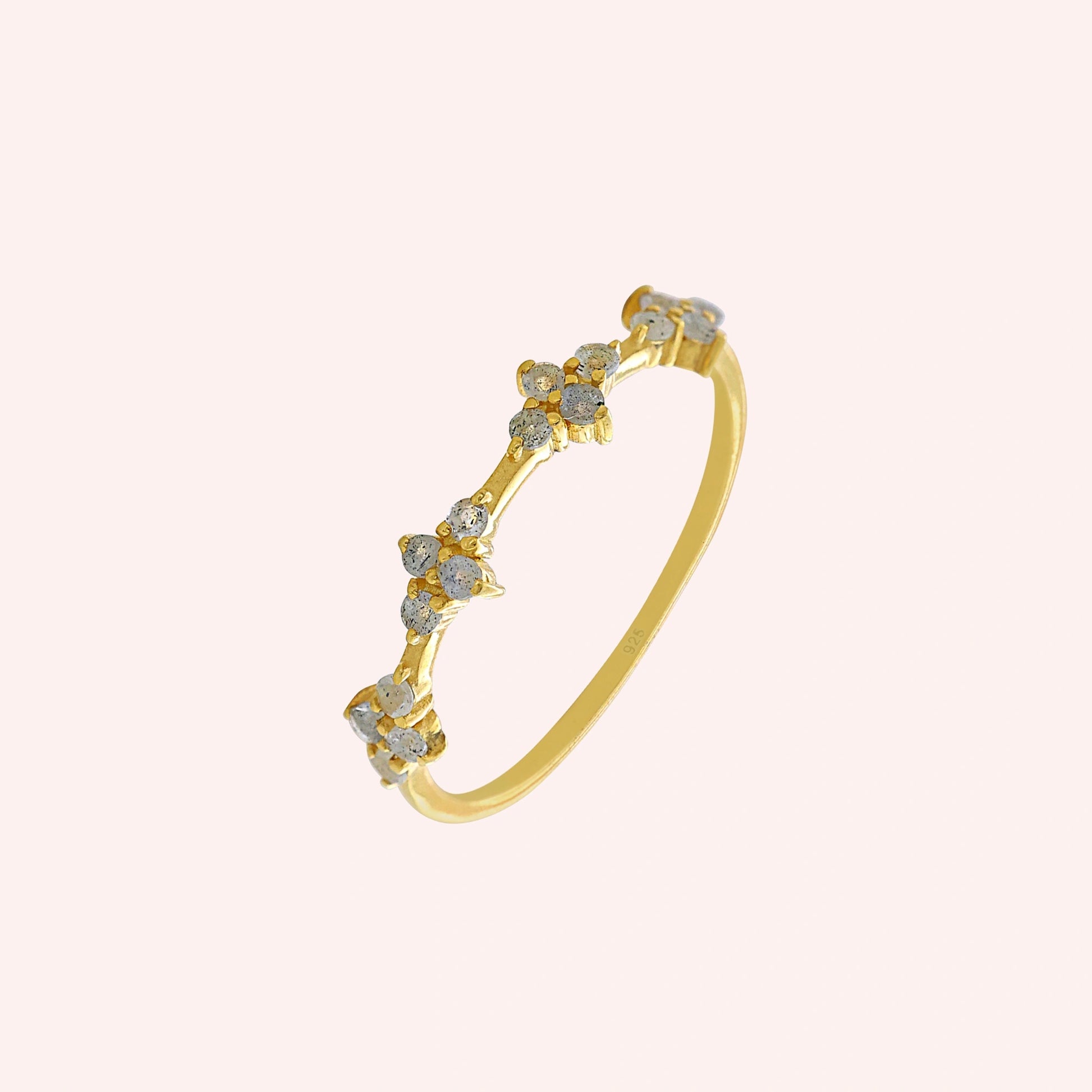 Cluster_ring_gold_plated_silver_band_with_small_clusters_and_labradorite_stones_slightly_tilted_on_solid_pink_background