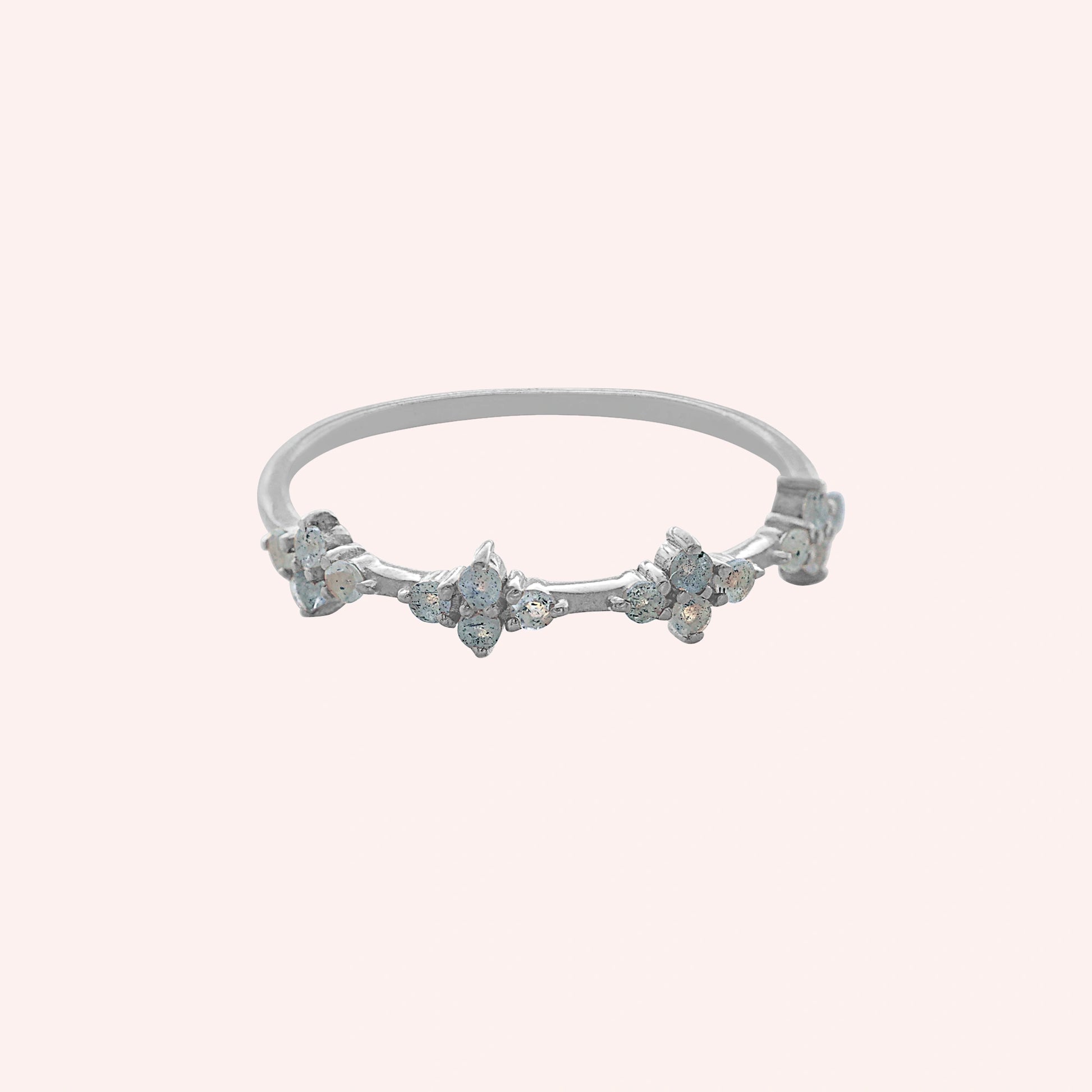 Cluster_ring_sterling_silver_band_with_small_clusters_and_labradorite_stones_at_front_angle_on_solid_pink_background
