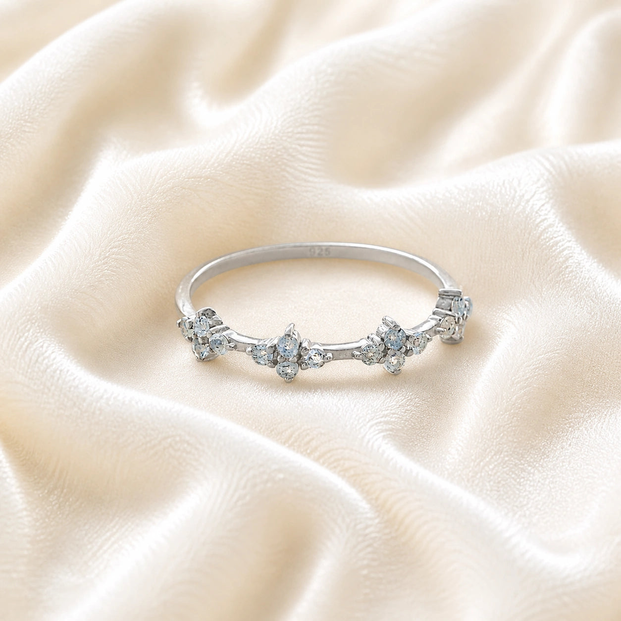 Cluster_ring_sterling_silver_band_with_small_clusters_and_labradorite_stones_at_front_angle_on_soft_fabric_background
