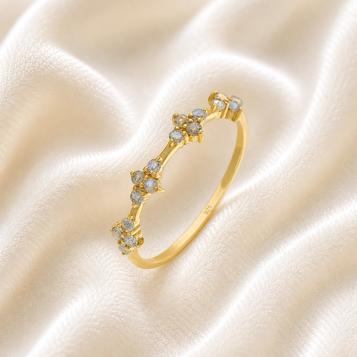 Cluster_ring_gold_plated_silver_band_with_small_clusters_and_labradorite_stones_slightly_tilted_on_soft_fabric_background