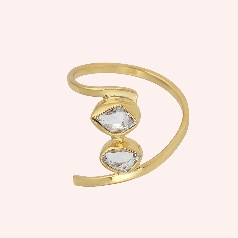 Cocktail_ring_with_open_gold_plated_silver_band_and_two_herkimer_stones_shown_at_front_angle_on_solid_pink_background