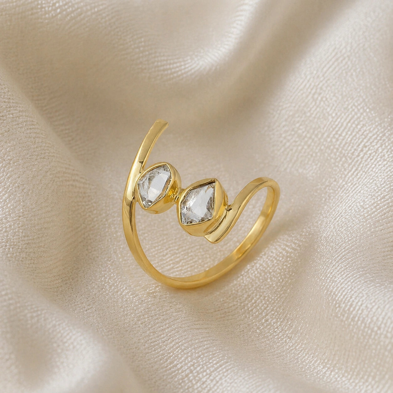 Cocktail_ring_with_open_gold_plated_silver_band_and_two_herkimer_stones_shown_at_slightly_angled_on_soft_fabric_background