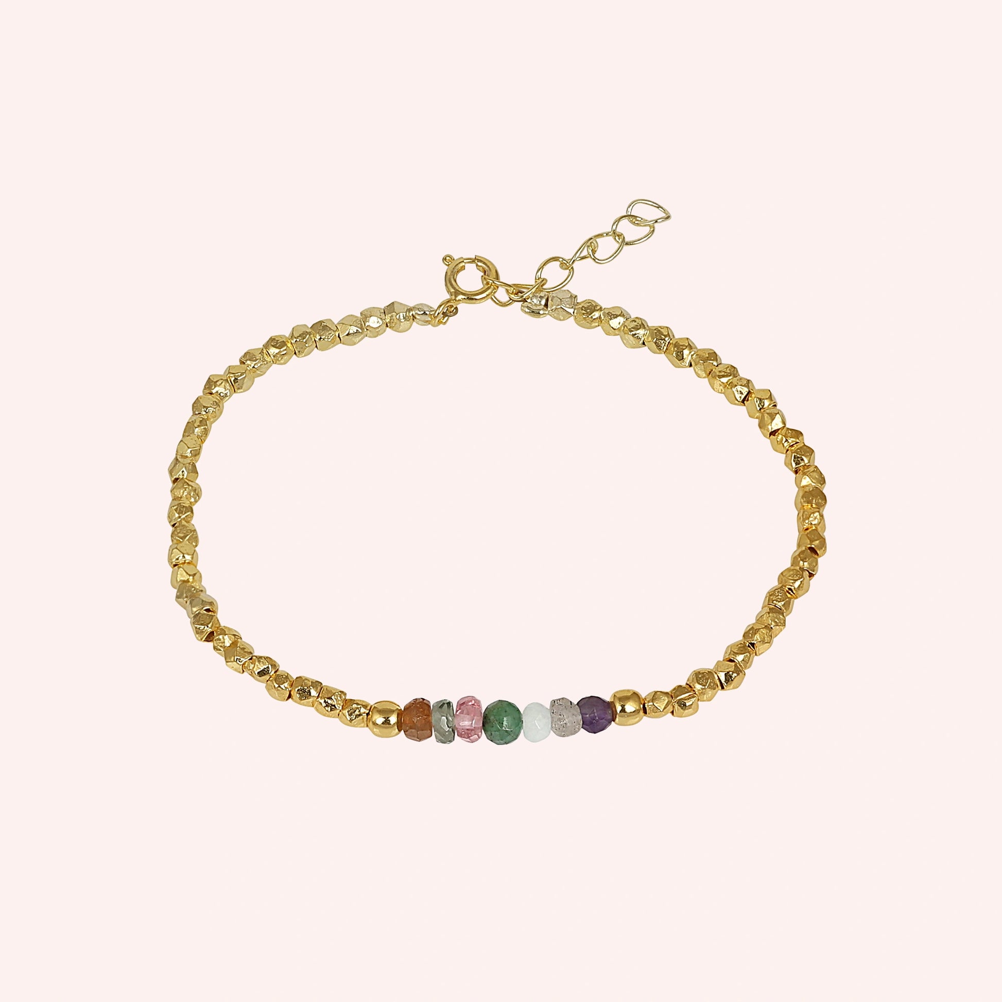 top_angle_colorful_beaded_bracelet_multi_gemstone_bracelet_gold_plated_beads_with_chain_clasp_on_soft_pink_background