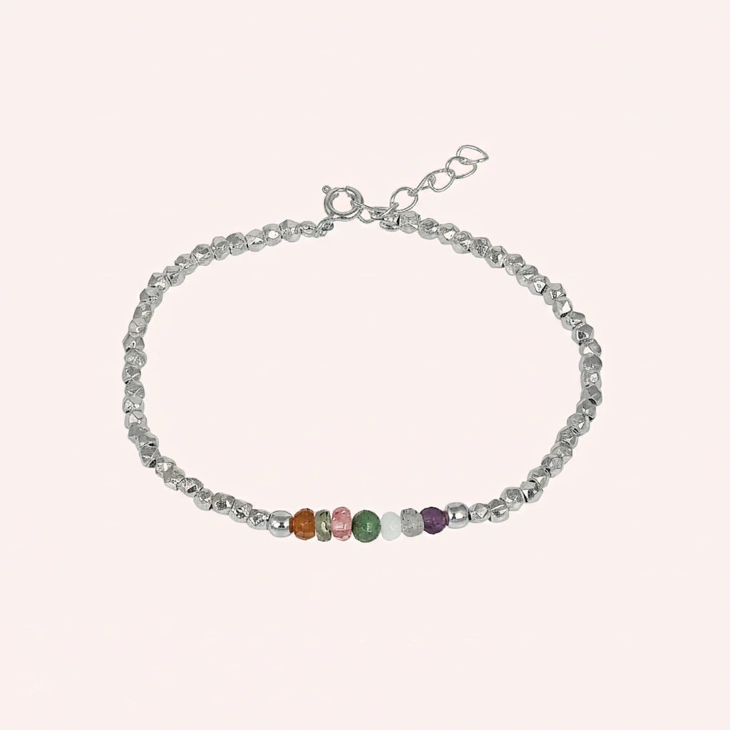 top_angle_colorful_beaded_bracelet_multi_gemstone_bracelet_with_silver_beads_and_chain_on_soft_pink_background