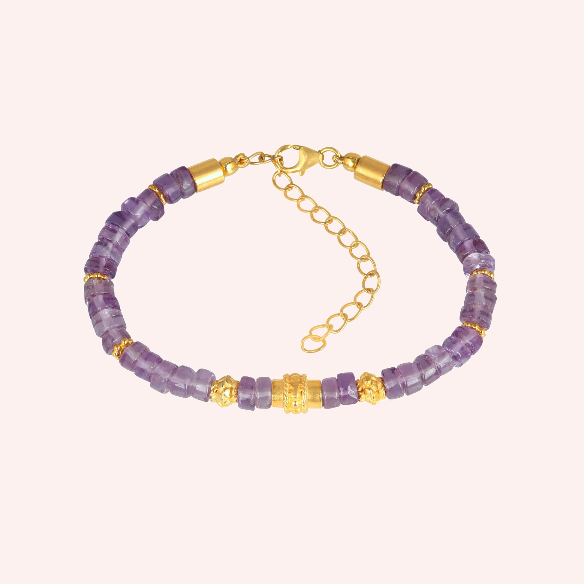top_angle_crystal_bracelet_with_faceted_amethyst_stones_and_gold_plated_clasp_amethyst_bracelet_on_soft_cream_background