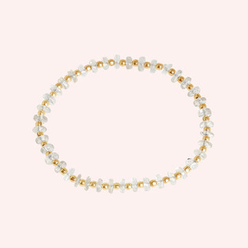 Crystal_bracelet_with_crystal_and_gold_plated_silver_beads_at_front_angle_view_on_solid_pink_background