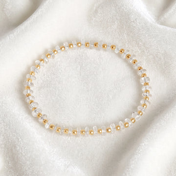 Crystal_bracelet_with_crystal_and_gold_plated_silver_beads_at_front_angle_view_on_soft_fabric_background