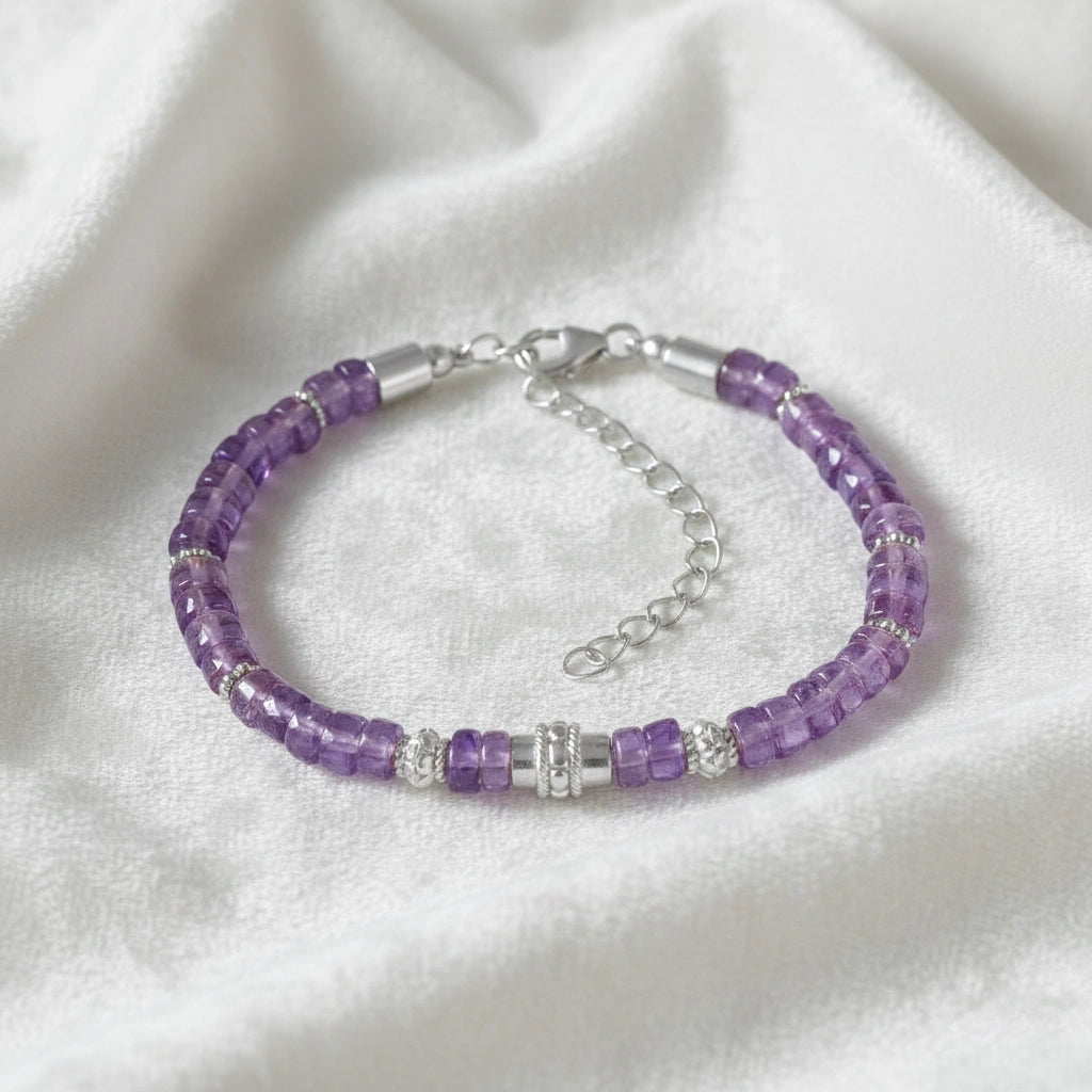 top_angle_crystal_bracelet_with_faceted_amethyst_stones_and_silver_clasp_amethyst_bracelet_on_soft_white_fabric_background