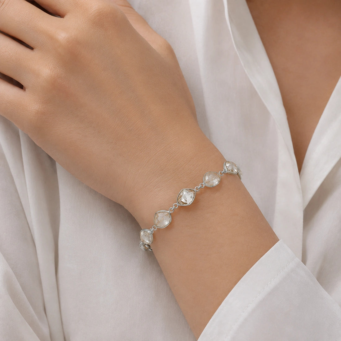 Crystal_bracelet_in_gold_plated_silver_with_raw_herkimer_stones_at_front_angle_view_on_soft_fabric_background