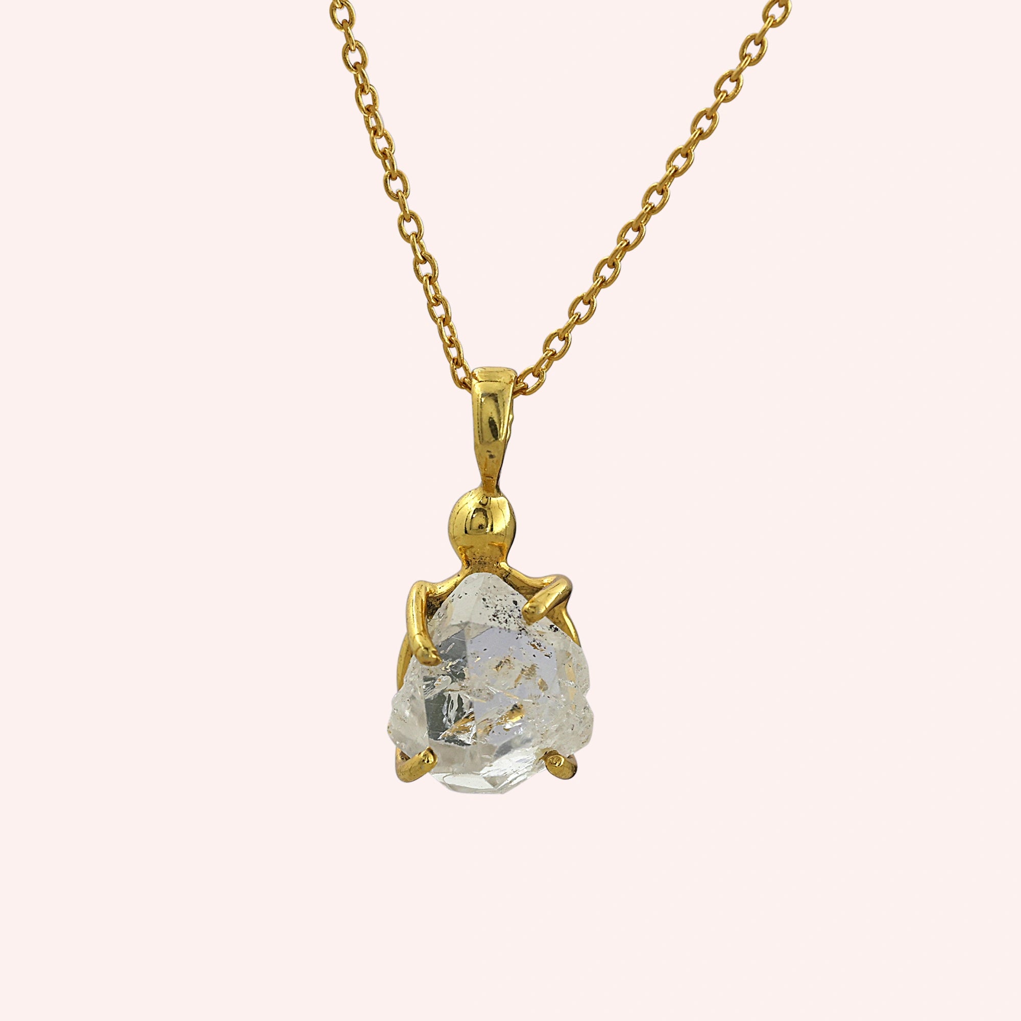 Crystal_necklace_in_gold_plated_silver_with_raw_stone_on_fine_chain_shown_in_front_angle_on_solid_pink_background