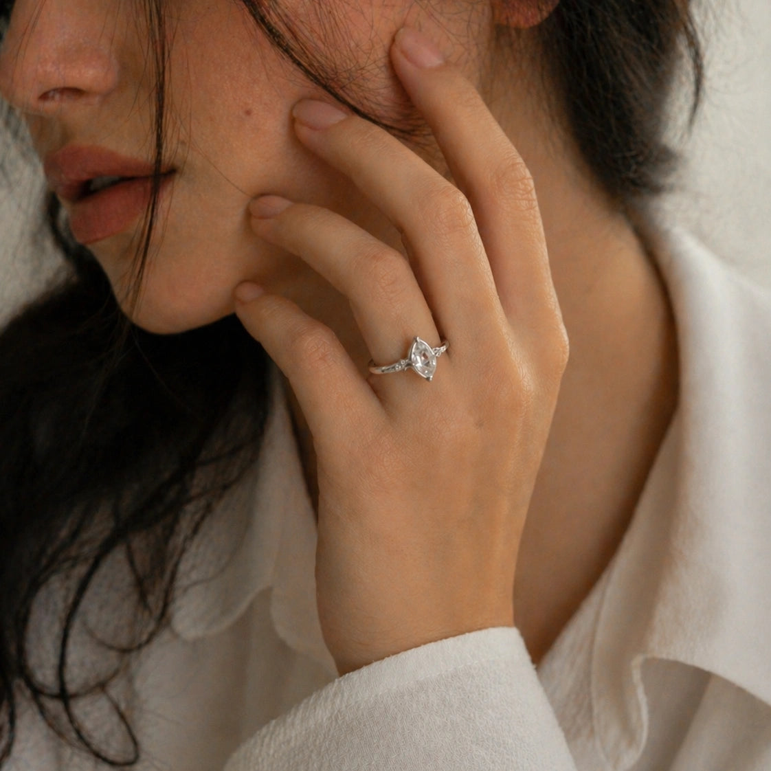Crystal_ring_in_sterling_silver_with_raw_herkimer_stone_in_front_angle_view_worn_by_a_model