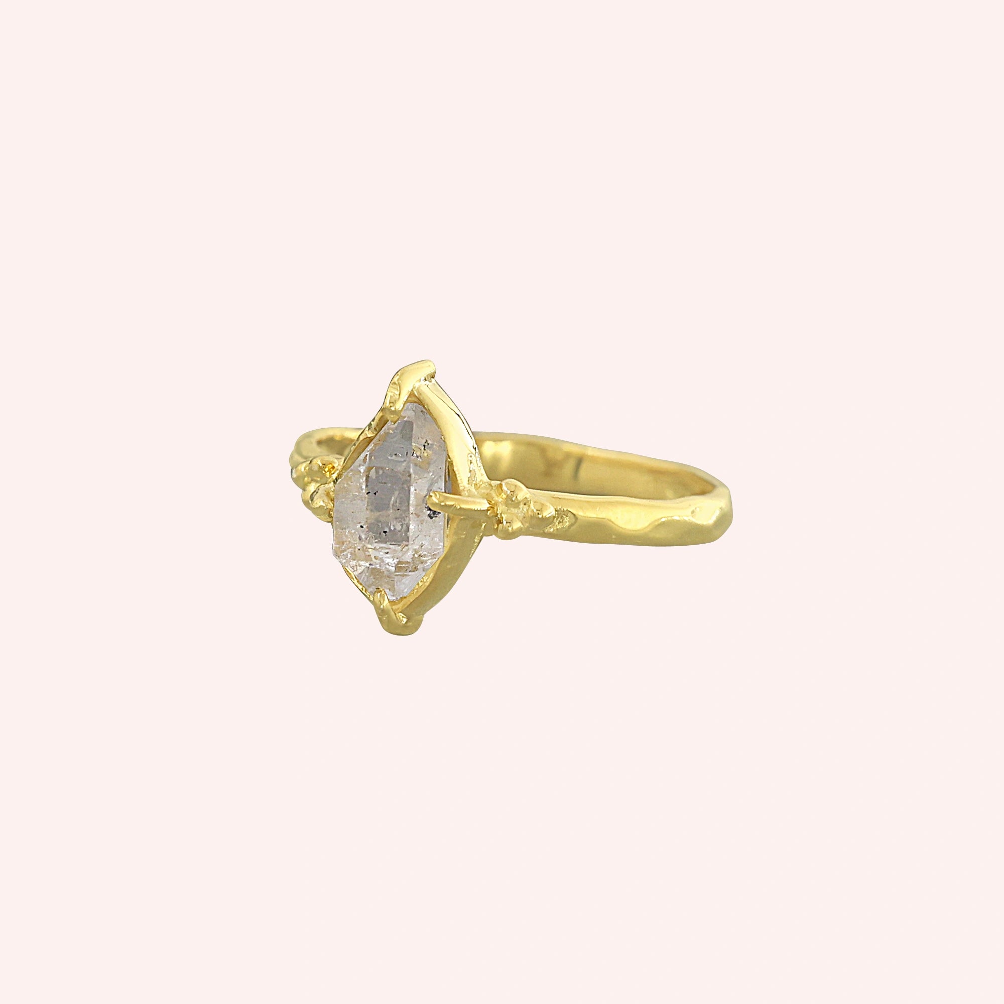 Crystal_ring_in_gold_plated_silver_with_raw_herkimer_stone_in_slight_tilted_view_on_soft_fabric_background