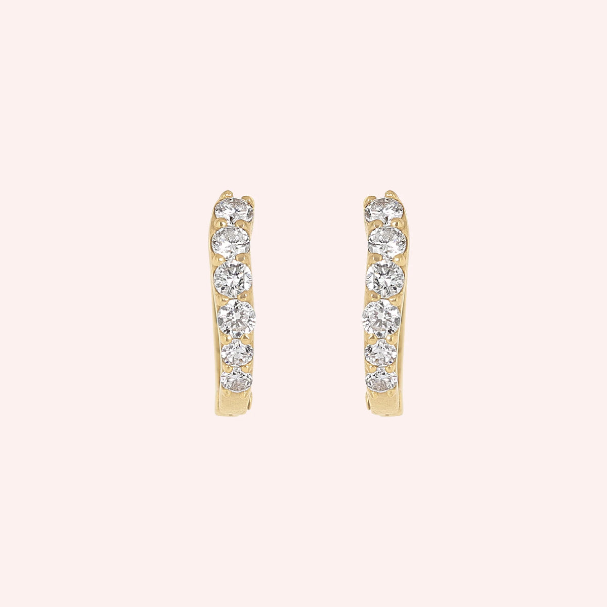 Cute_earrings_in_gold_plated_silver_with_CZ_stones_at_front_angle_view_on_solid_pink_background