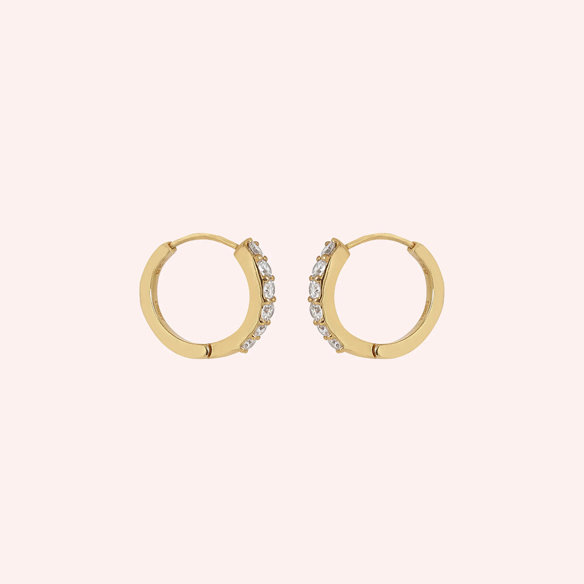 Cute_earrings_in_gold_plated_silver_with_CZ_stones_at_side_angle_view_on_solid_pink_background