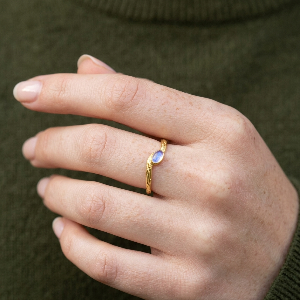 Cute_ring_gold_plated_silver_with_oval_moonstone_and_textured_wave_band_worn_by_a_model