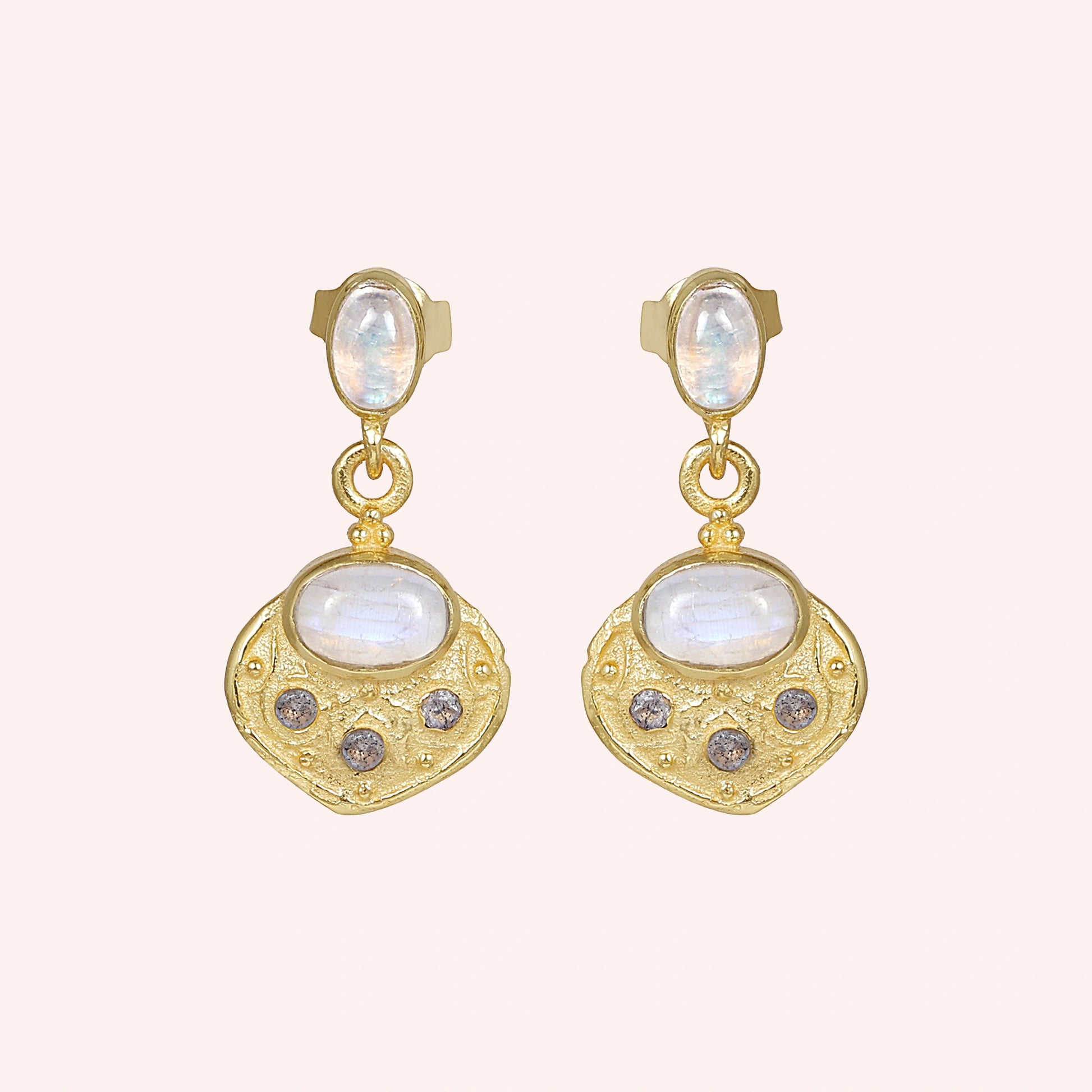 Dangle_earrings_in_gold_plated_silver_with_moonstone_and_labradorite_shown_at_front_angle_on_solid_pink_background