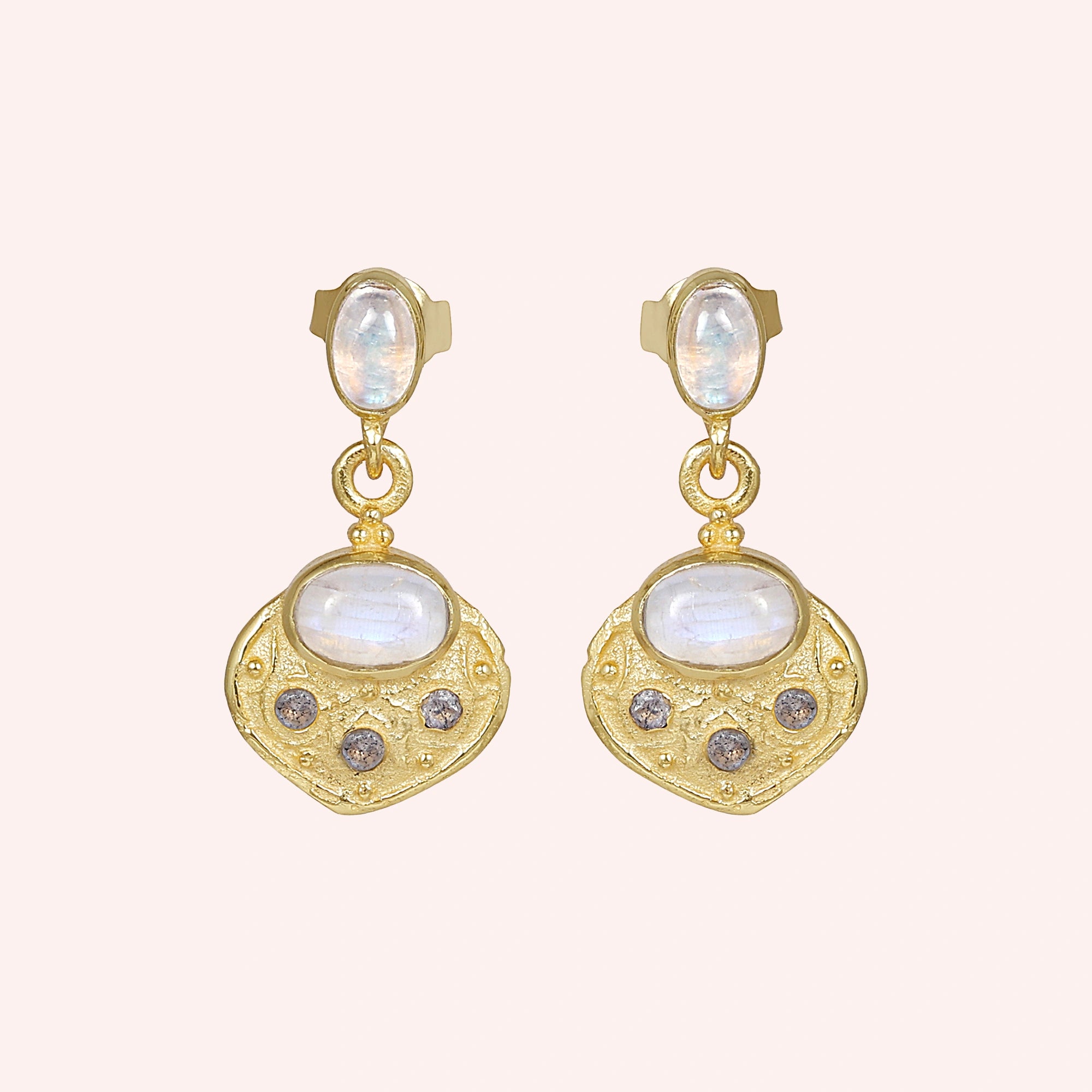 Dangle_earrings_in_gold_plated_silver_with_moonstone_and_labradorite_shown_at_front_angle_on_solid_pink_background