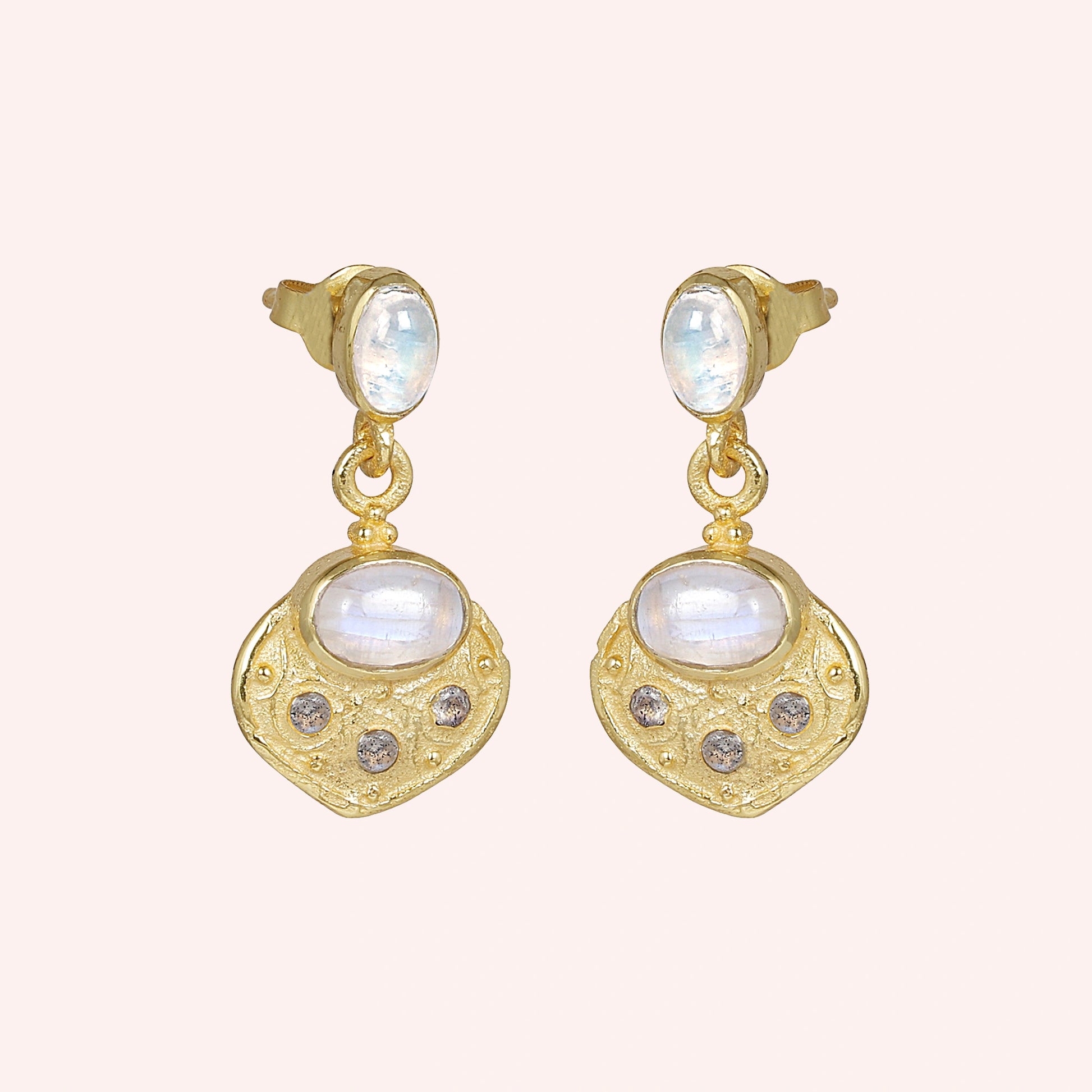 Dangle_earrings_in_gold_plated_silver_with_moonstone_and_labradorite_shown_at_slightly_angled_on_solid_pink_background