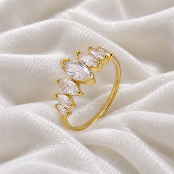 Designer_ring_in_gold_plated_silver_with_marquise_cut_CZ_stones_at_side_angle_view_on_soft_fabric_background