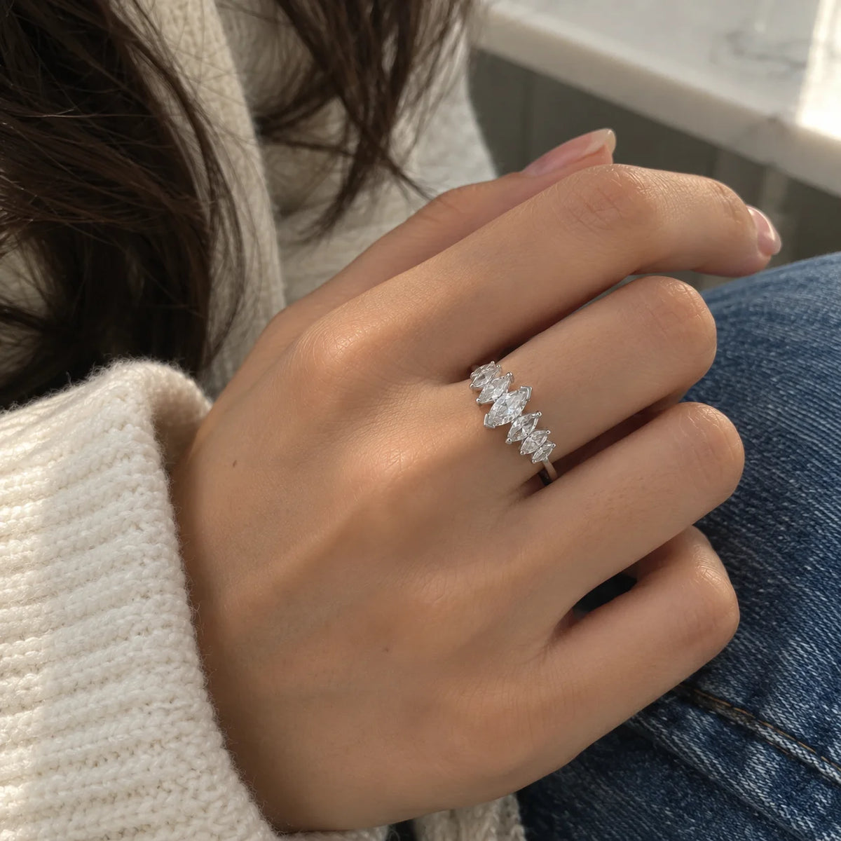 Designer_ring_in_sterling_silver_with_marquise_cut_CZ_stones_at_front_angle_view_worn_by_a_model