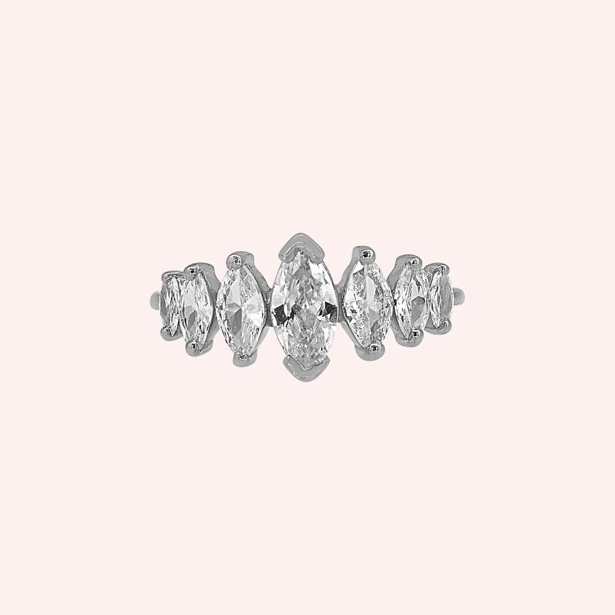 Designer_ring_in_sterling_silver_with_marquise_cut_CZ_stones_at_front_angle_view_on_solid_pink_background