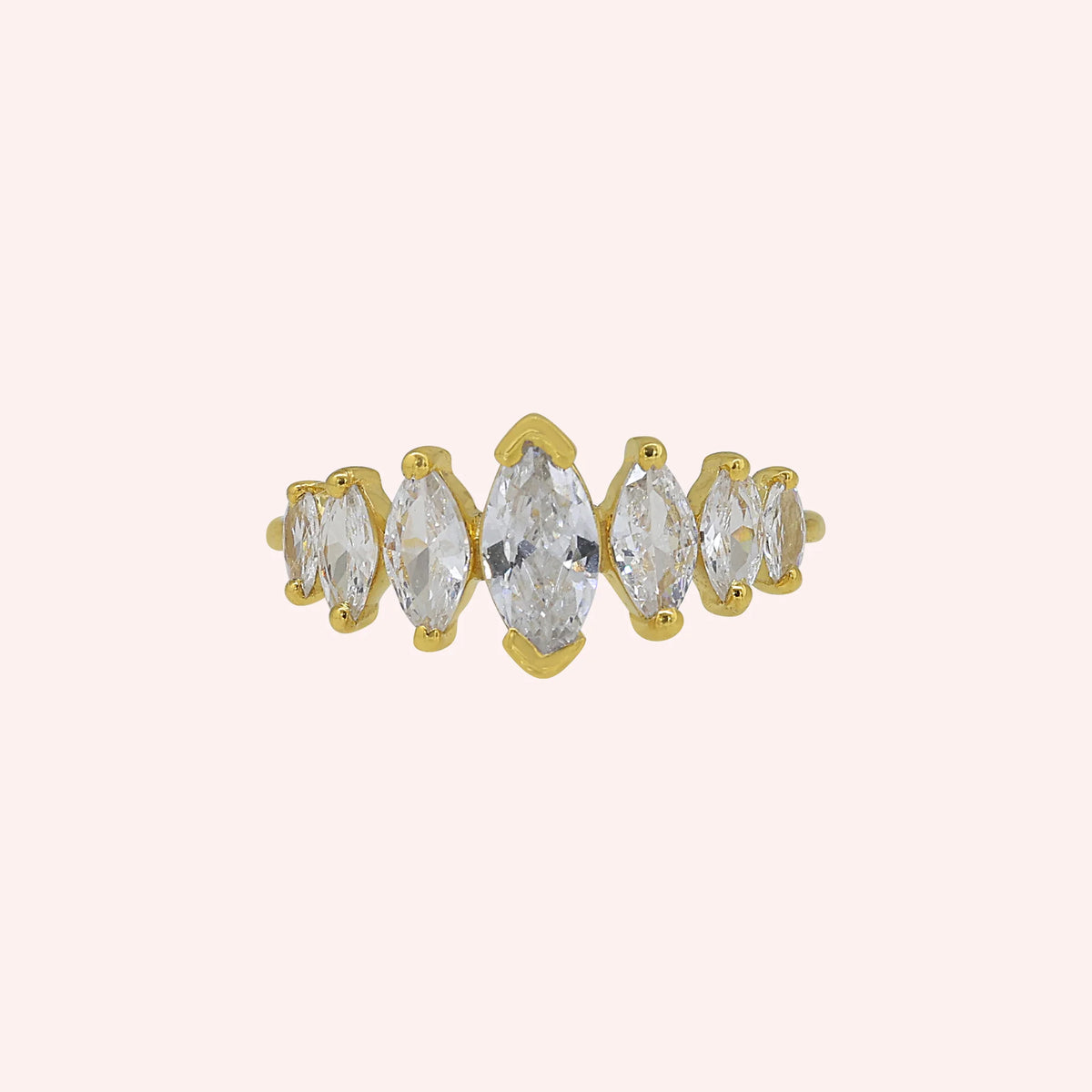 Designer_ring_in_gold_plated_silver_with_marquise_cut_CZ_stones_at_front_angle_view_on_solid_pink_background