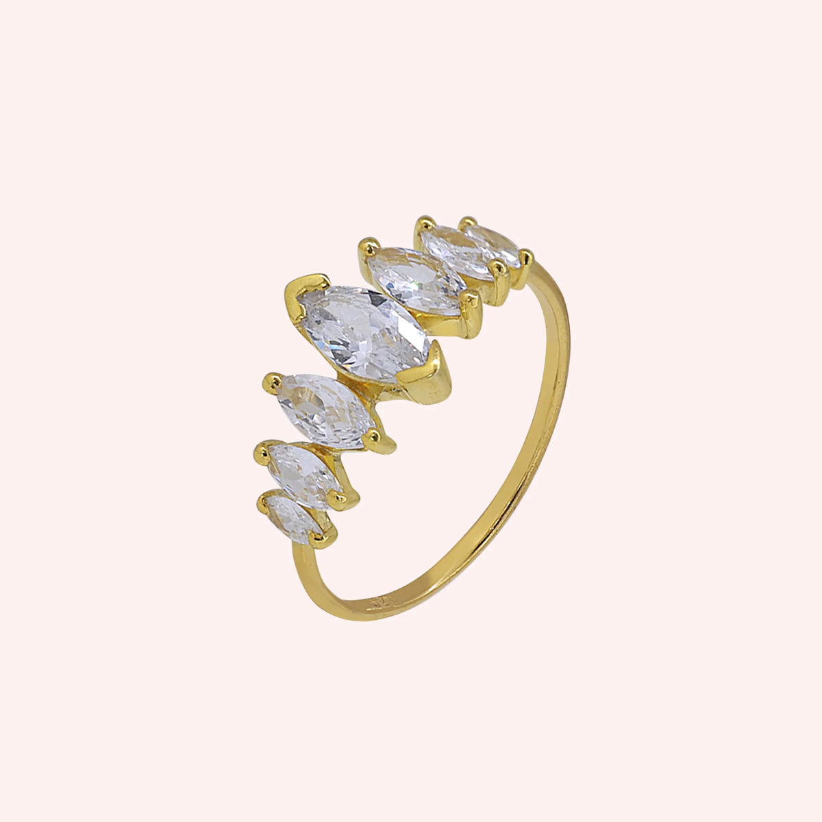 Designer_ring_in_gold_plated_silver_with_marquise_cut_CZ_stones_at_side_angle_view_on_solid_pink_background