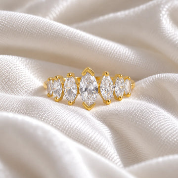 Designer_ring_in_gold_plated_silver_with_marquise_cut_lab_grown_diamonds_at_front_angle_view_on_soft_fabric_background