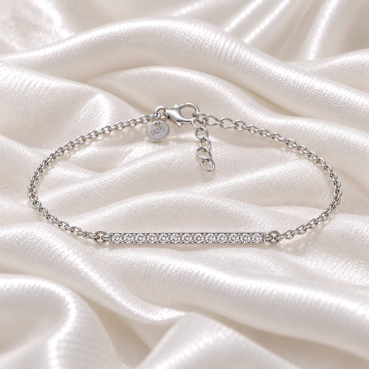 Diamond_bracelet_in_sterling_silver_with_a_bar_design_at_front_angle_view_on_soft_fabric_background