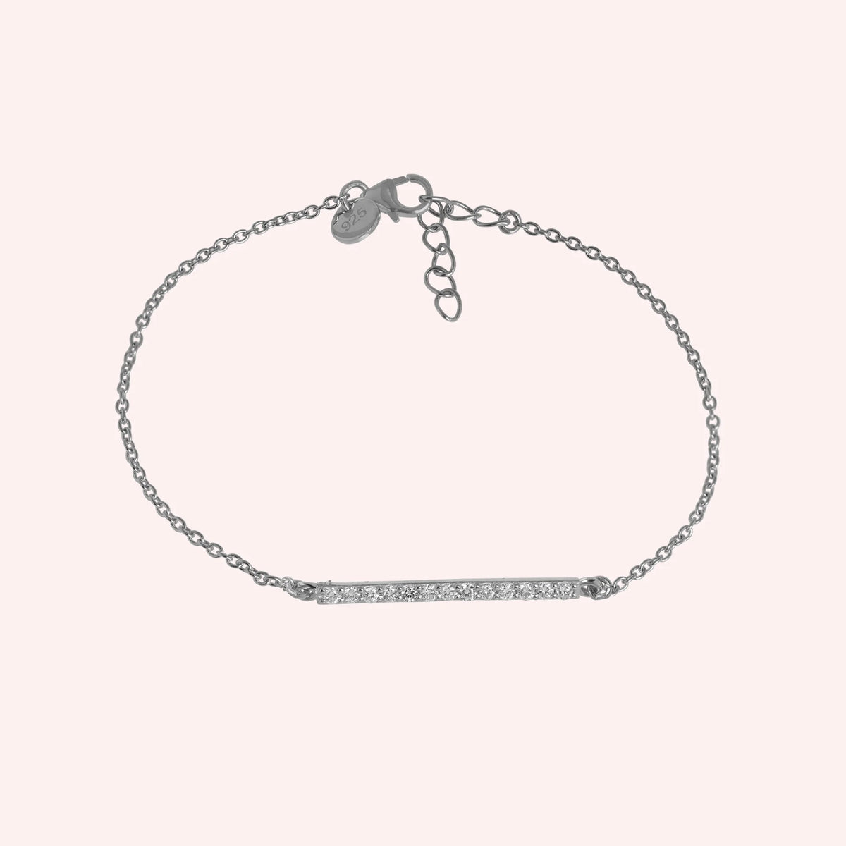 Diamond_bracelet_in_sterling_silver_with_a_bar_design_at_front_angle_view_on_solid_pink_background
