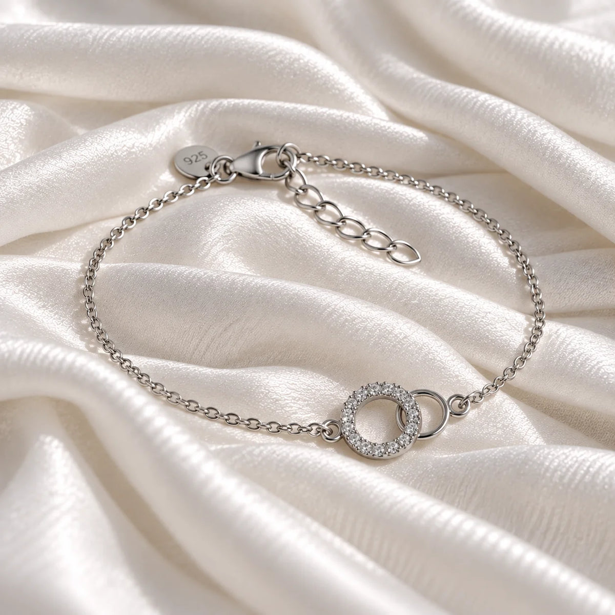 Diamond_bracelet_in_sterling_silver_in_an_interlocking_design_at_slight_angle_view_on_soft_fabric_background
