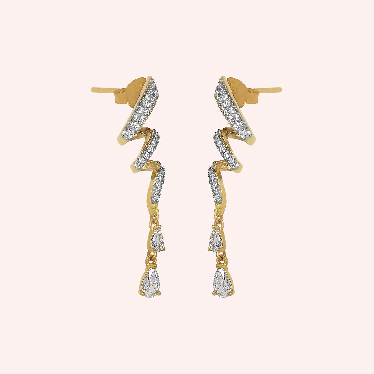 Diamond_drop_earrings_in_gold_plated_silver_with_twisted_design_lab_grown_diamonds_at_side_angle_view_on_solid_pink_background