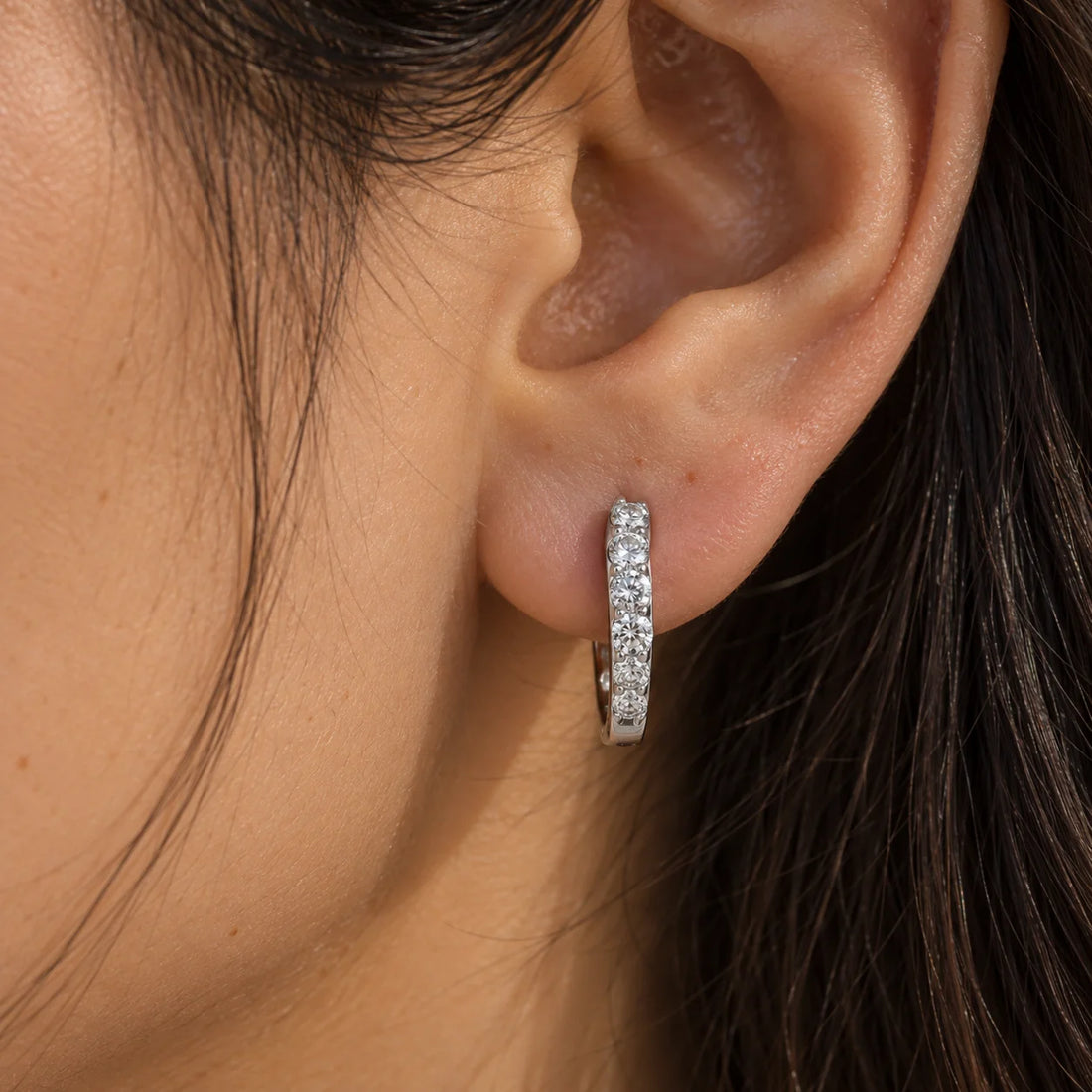 Diamond_hoop_earrings_in_gold_plated_silver_with_lab_grown_diamonds_at_front_angle_view_on_soft_fabric_background