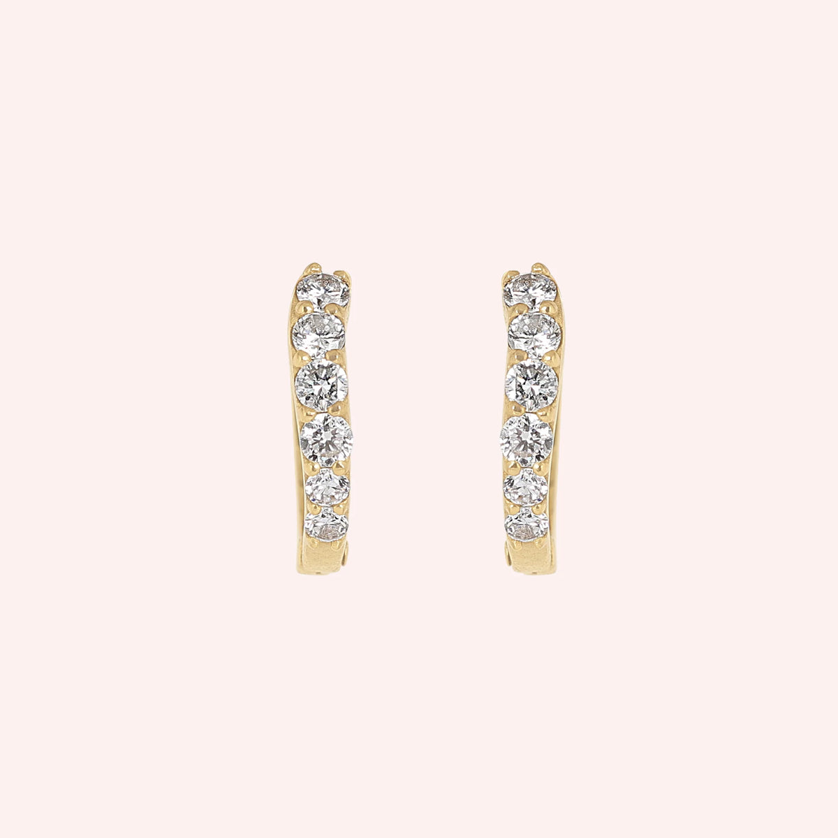 Diamond_hoop_earrings_in_gold_plated_silver_with_lab_grown_diamonds_at_front_angle_view_on_solid_pink_background