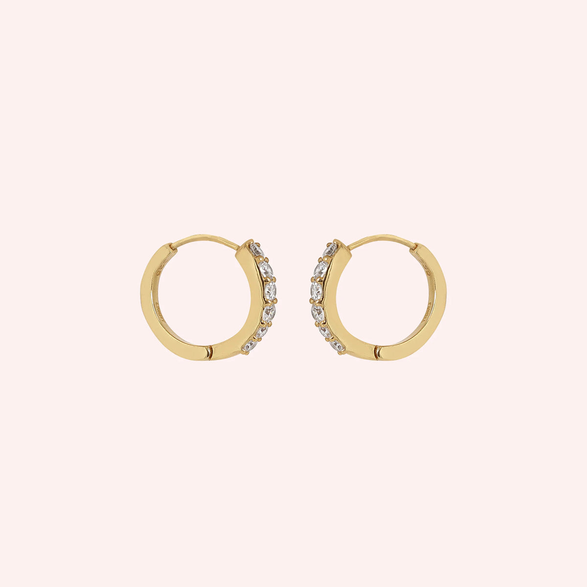 Diamond_hoop_earrings_in_gold_plated_silver_with_lab_grown_diamonds_at_slight_angle_view_on_solid_pink_background