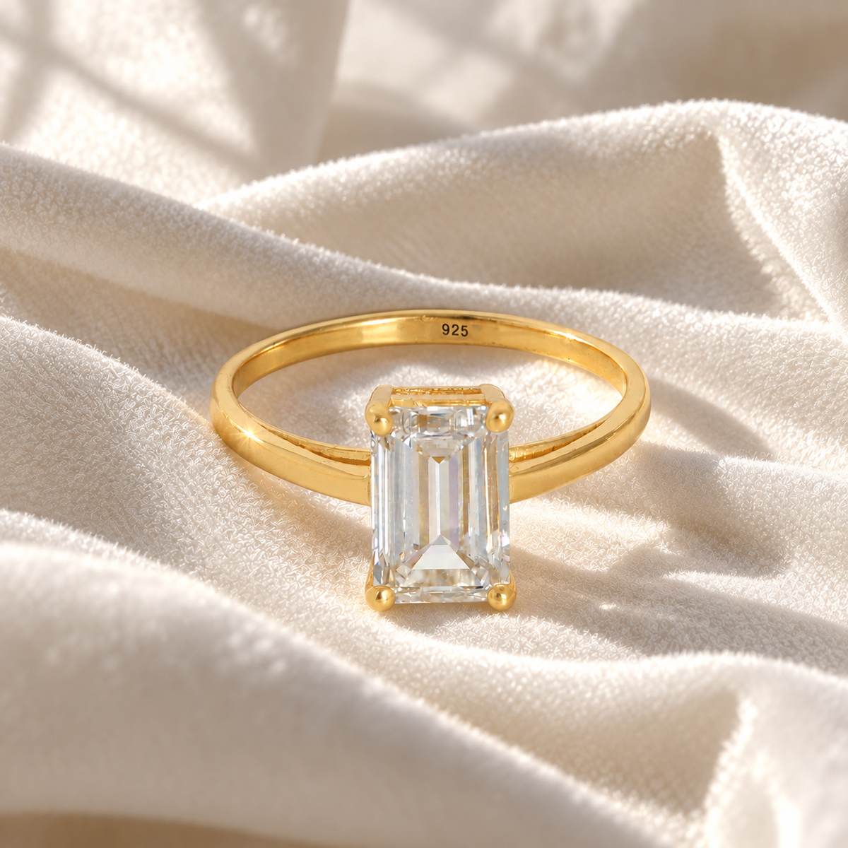 Diamond_ring_in_gold_plated_silver_with_a_lab_grown_baguette_shaped_diamond_at_front_view_on_soft_fabric_background