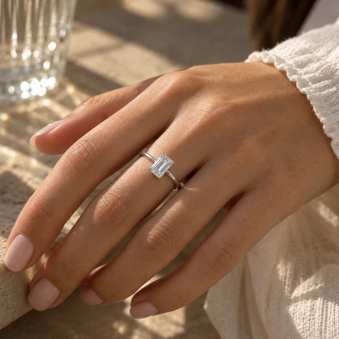 Diamond_ring_in_gold_plated_silver_with_a_lab_grown_baguette_shaped_diamond_at_front_view_on_soft_fabric_background