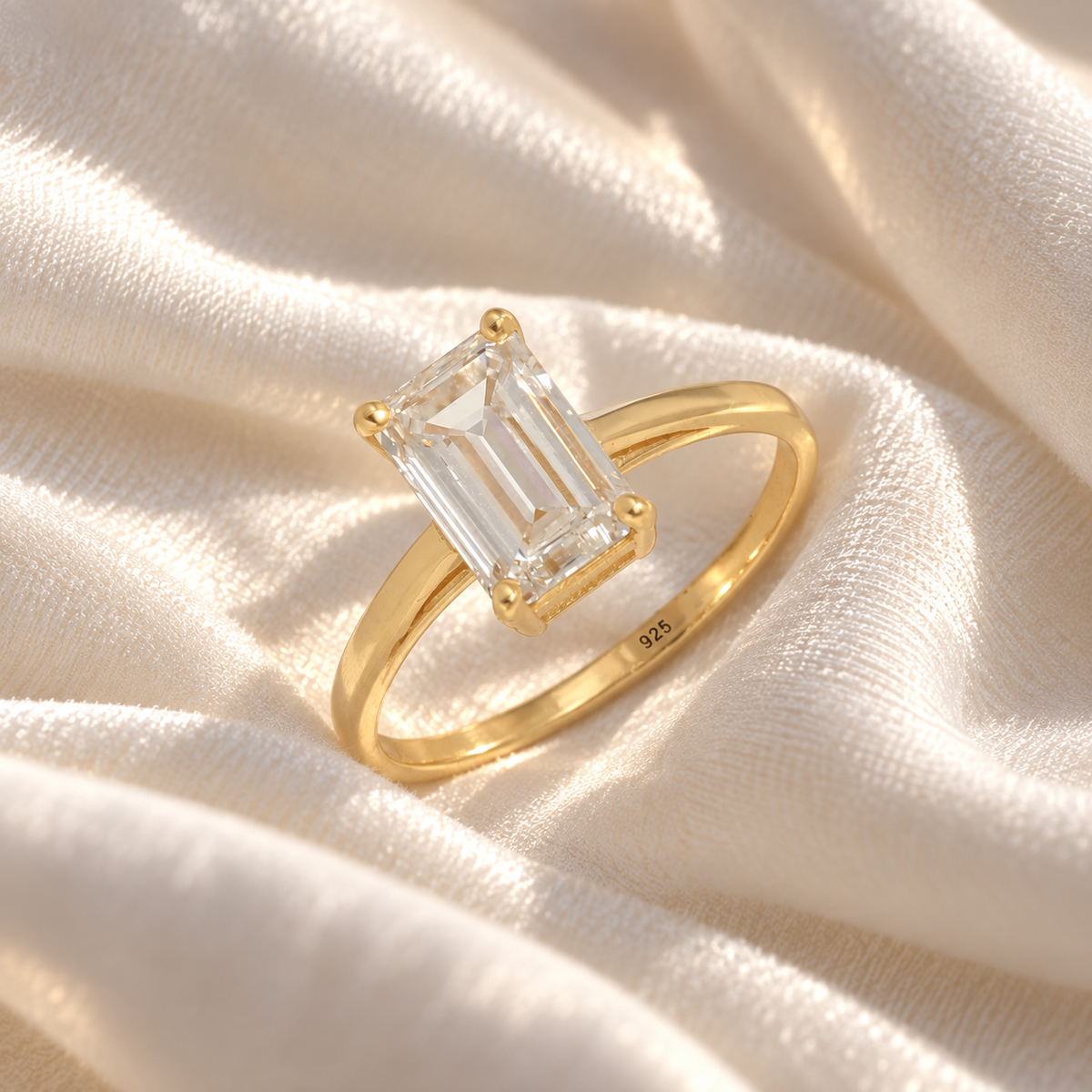 Diamond_ring_in_gold_plated_silver_with_a_lab_grown_baguette_shaped_diamond_at_slight_angle_view_on_soft_fabric_background