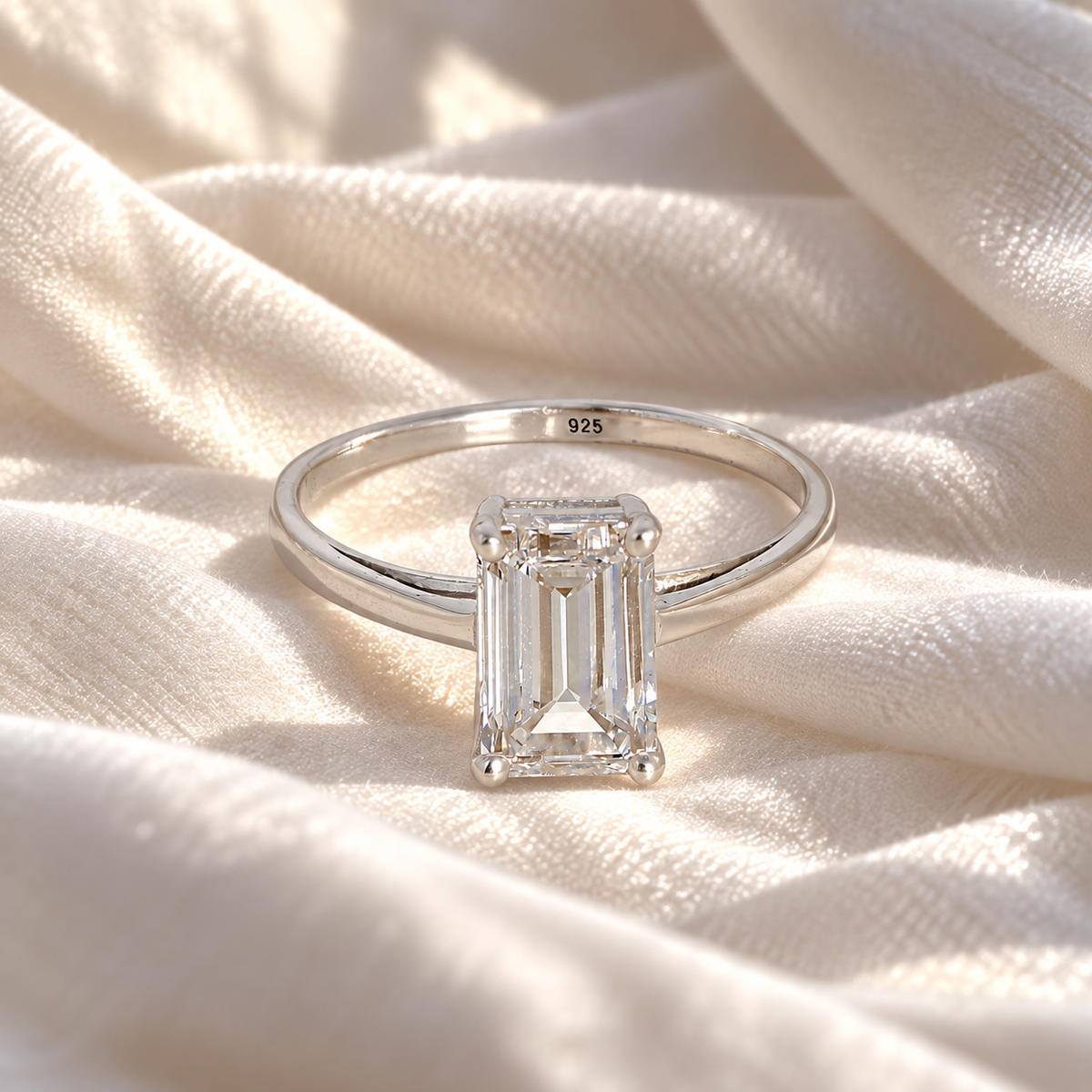 Diamond_ring_in_sterling_silver_with_a_lab_grown_baguette_shaped_diamond_at_front_view_on_soft_fabric_background