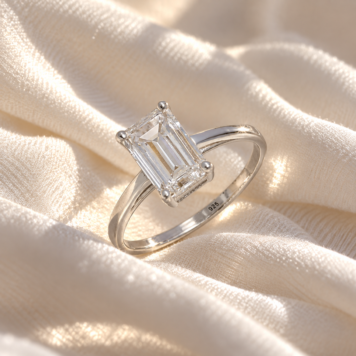 Diamond_ring_in_sterling_silver_with_a_lab_grown_baguette_shaped_diamond_at_slight_angle_view_on_soft_fabric_background