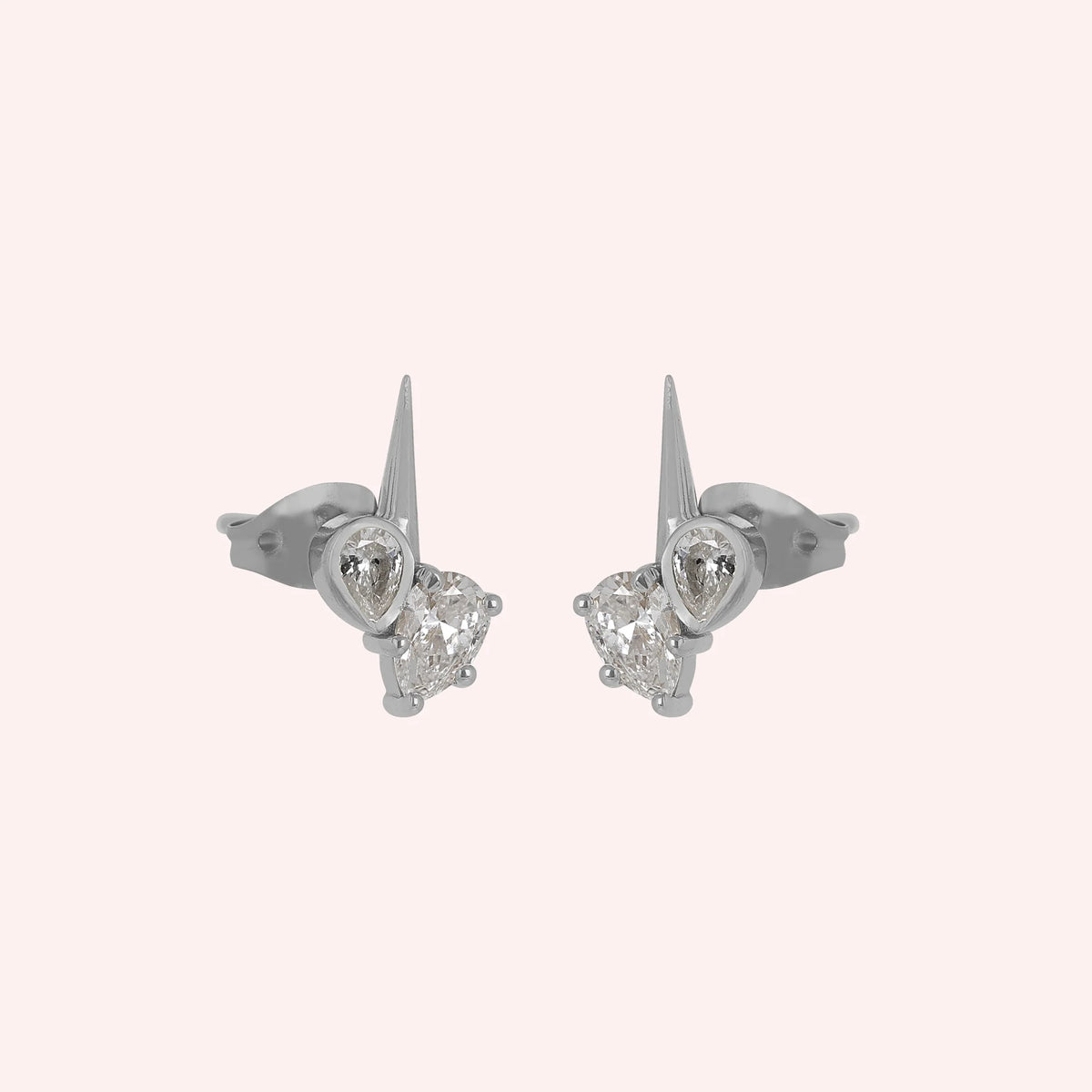 Diamond_stud_earrings_in_sterling_silver_with_teardrop_shaped_diamonds_at_slight_angle_view_on_solid_pink_background
